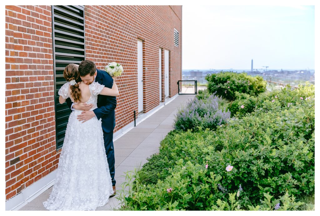 bride and groom hug after first look on rooftop of the line hotel in adams morgan washington dc
