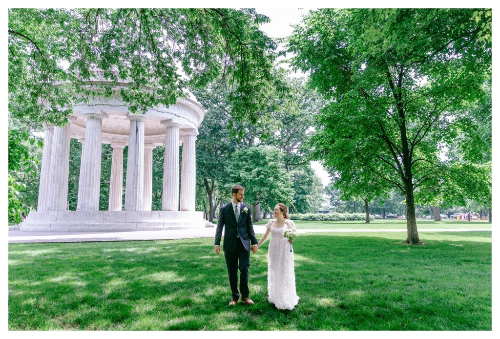 just married couple walking along national mall near dc war memorial after wedding ceremony in washington dc