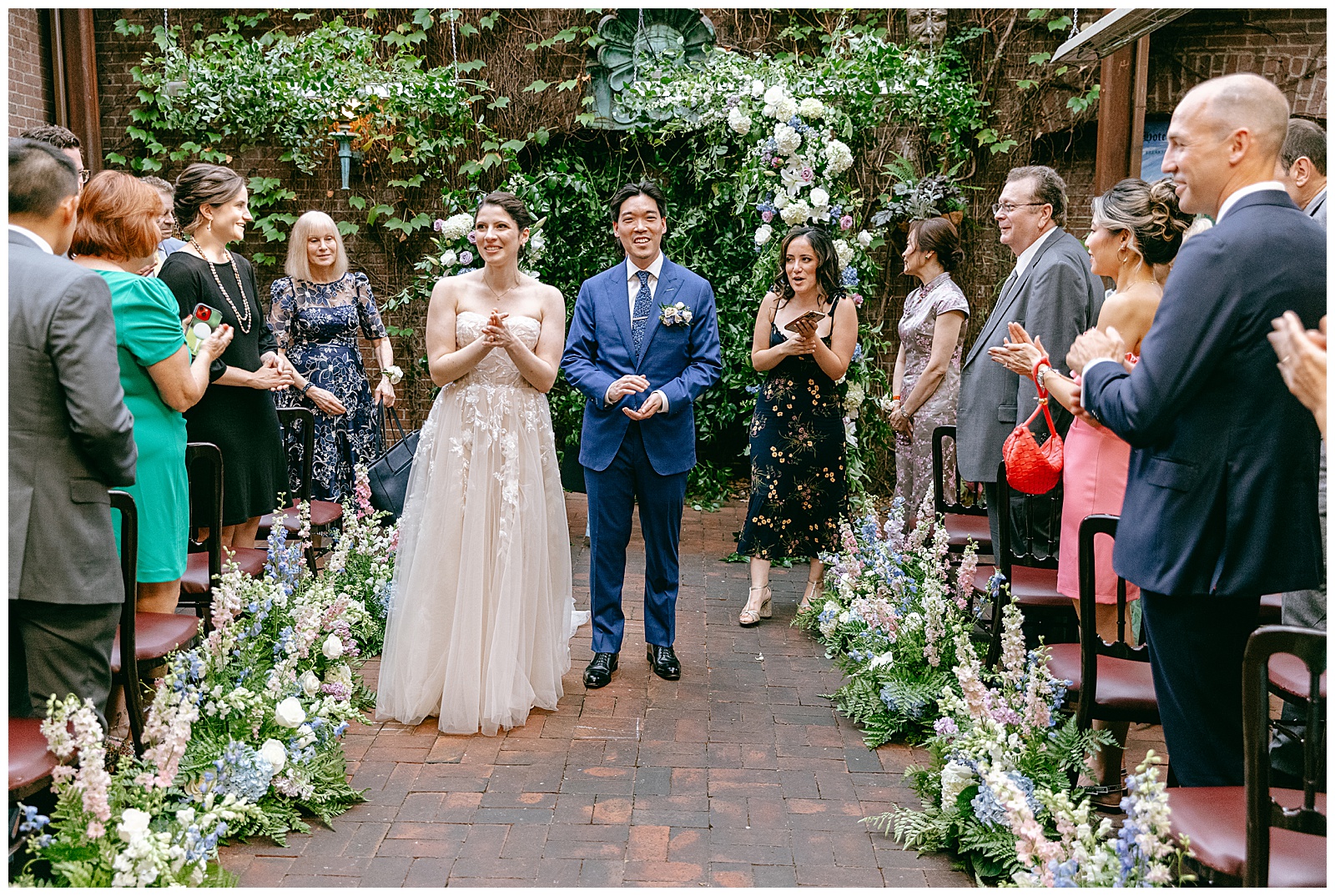 Couple just married with their wedding guests at ceremony venue