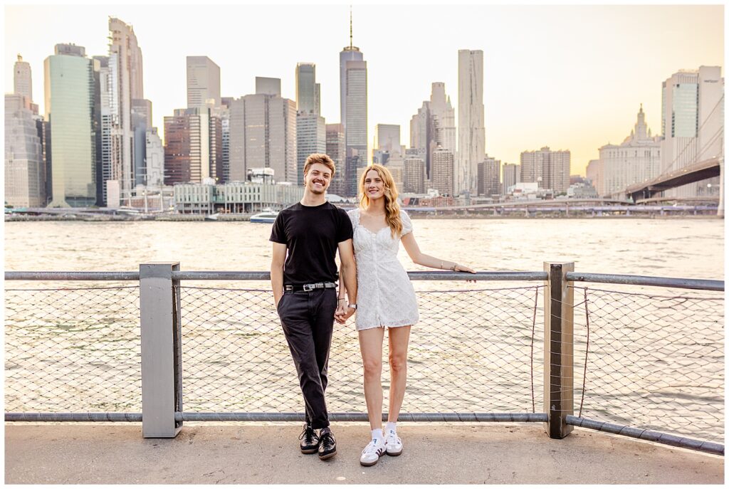 Brooklyn Bridge Park couple in front of water and Manhattan in the background