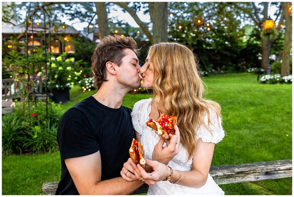 couple shares Ignazio's pizza slices in Jardin River Garden in Brooklyn, NY