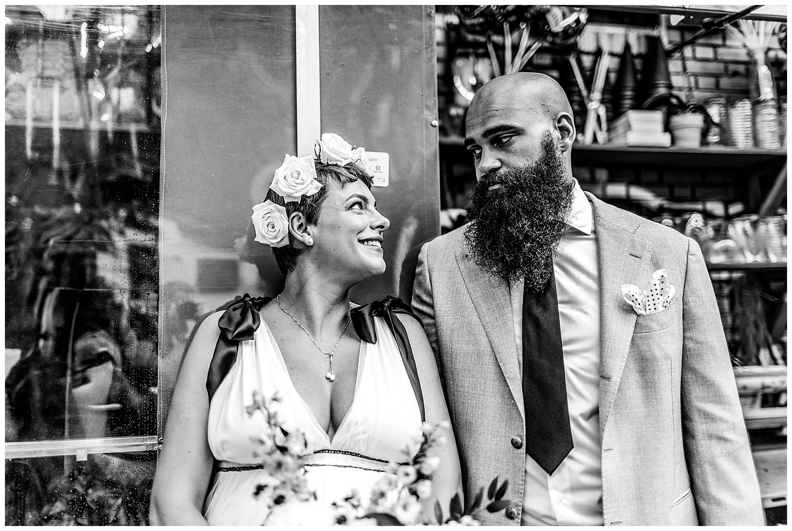 black and white photo of wedding couple looking at each other on Brooklyn city street