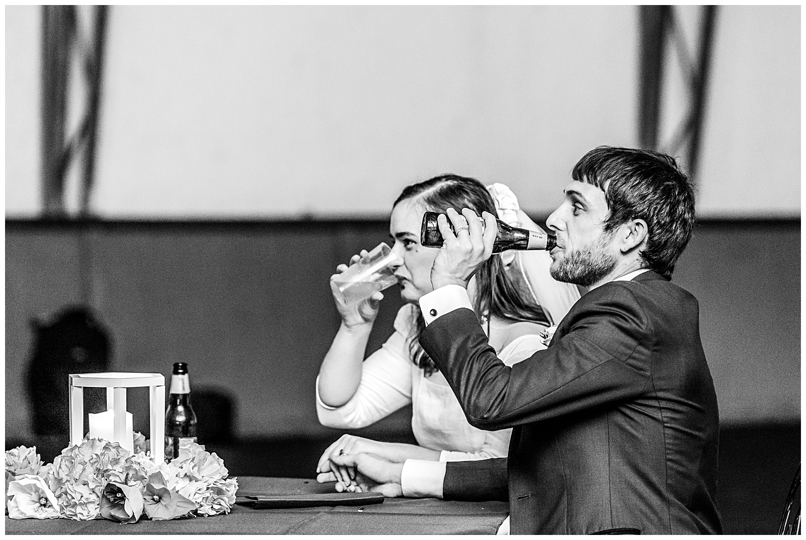 bride and groom enjoying taking a sip of their drinks during reception toasts