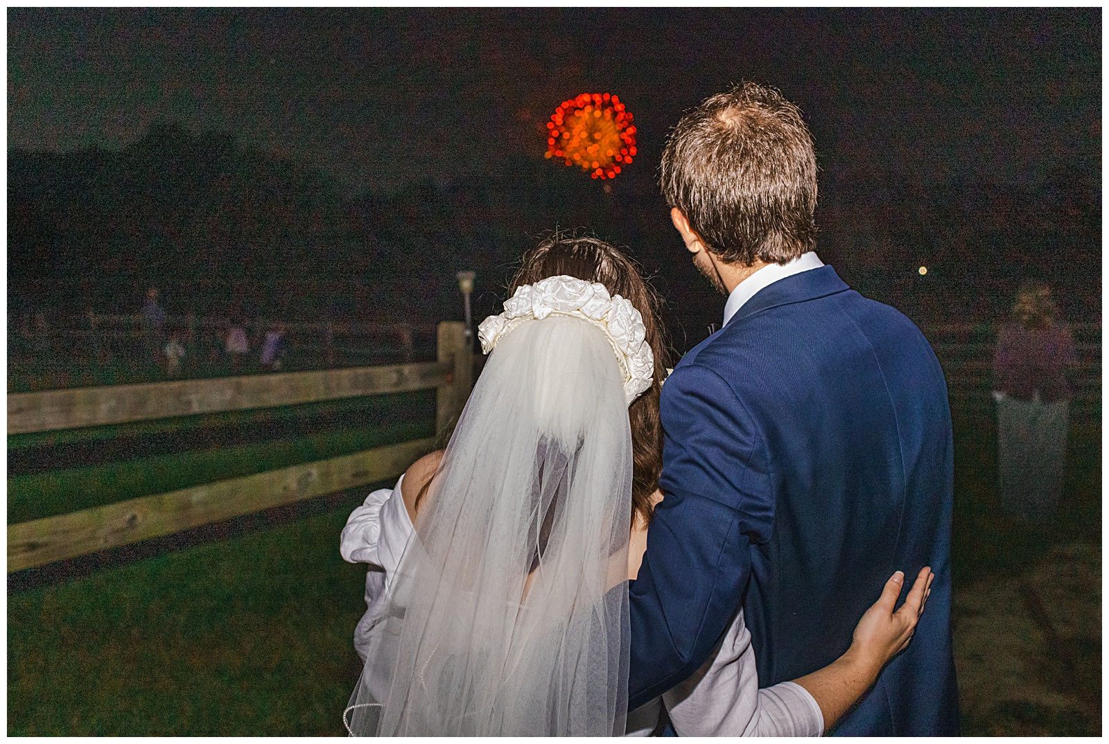 backside of couple shown as they are watching fireworks at the farm wedding venue near DC at Romantic Autumn Wedding at Fairwinds