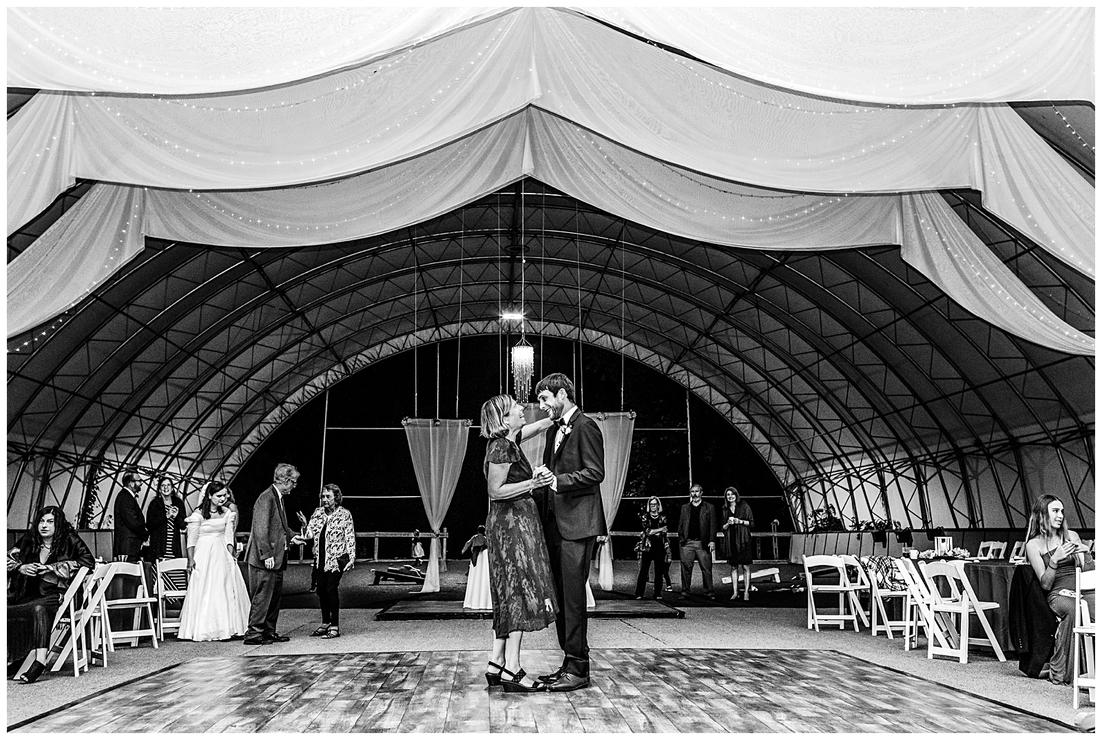 black and white portrait of mother son dance during wedding reception