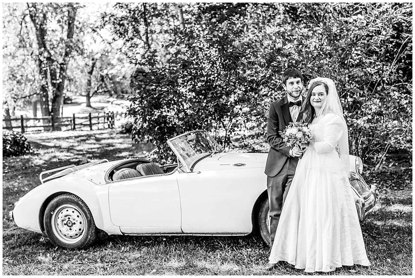 portrait of wedding couple by antique car