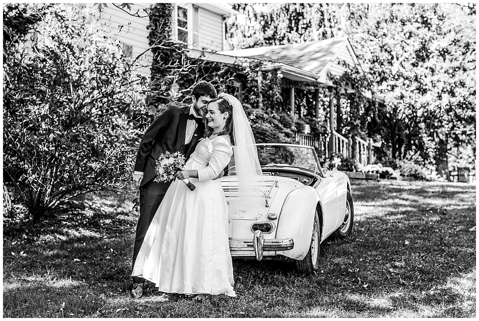 kissing and laughing photo of wedding couple by vintage MG car