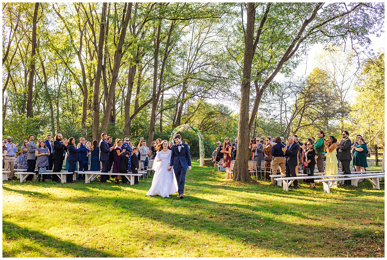 wide shot of bride and groom walking down aisle after being married Romantic Autumn Wedding at Fairwinds