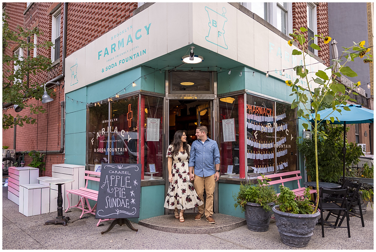 Candid moment of Stefanie and Brad laughing together at Brooklyn Farmacy in DUMBO.