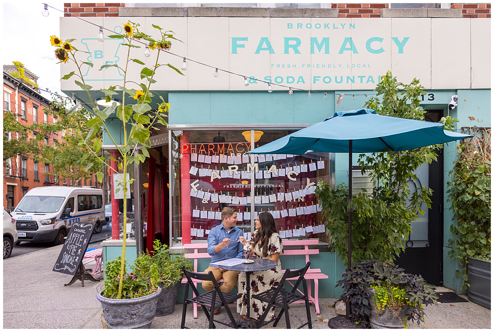 Romantic engagement photo of a couple with the Brooklyn Bridge and Manhattan skyline in the background.