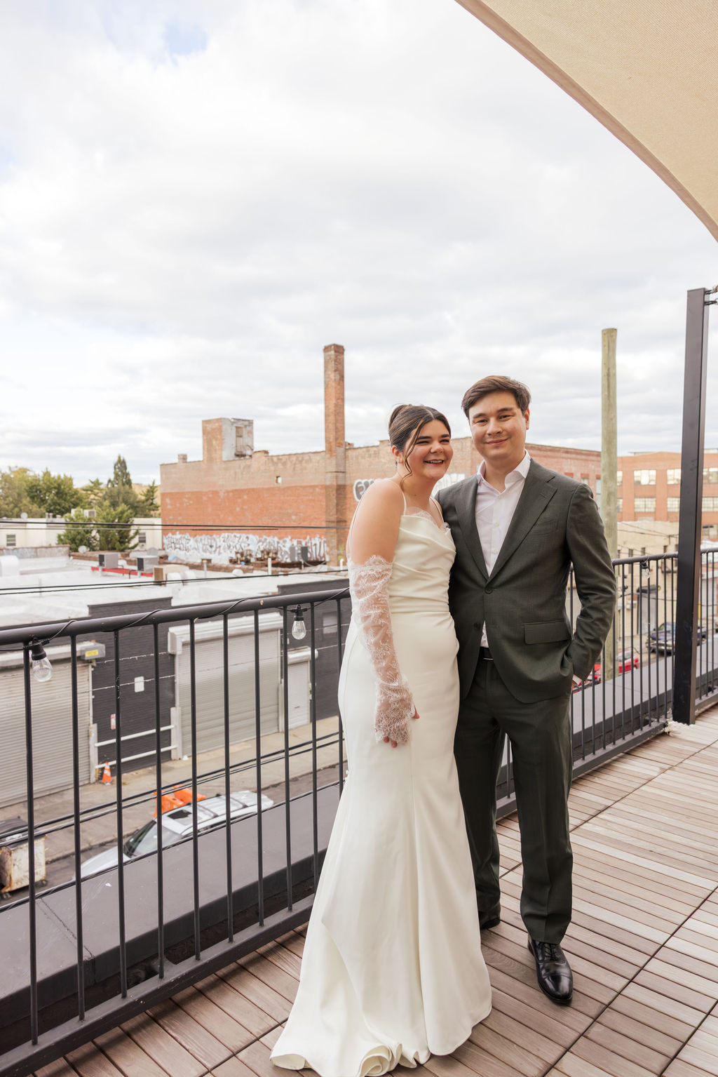 A nontraditional wedding portrait on terrace of GRIMM brewery in Brooklyn NYC