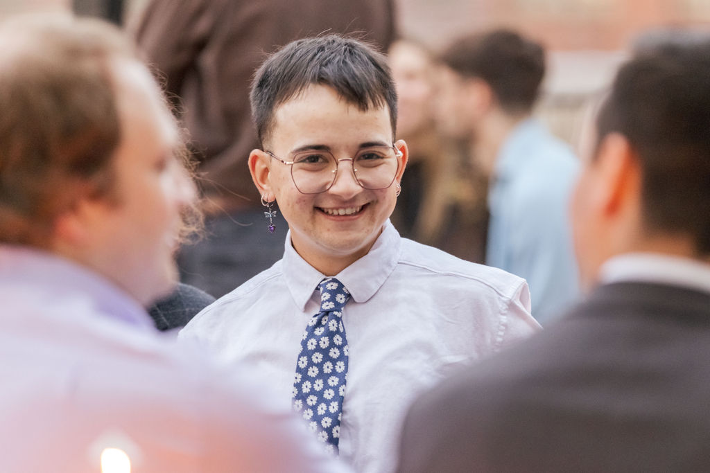 Guest smiling during candid moments at a queer non traditional wedding