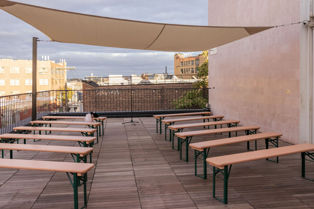 Empty rooftop ceremony space at a Brooklyn brewery before a non traditional wedding begins.