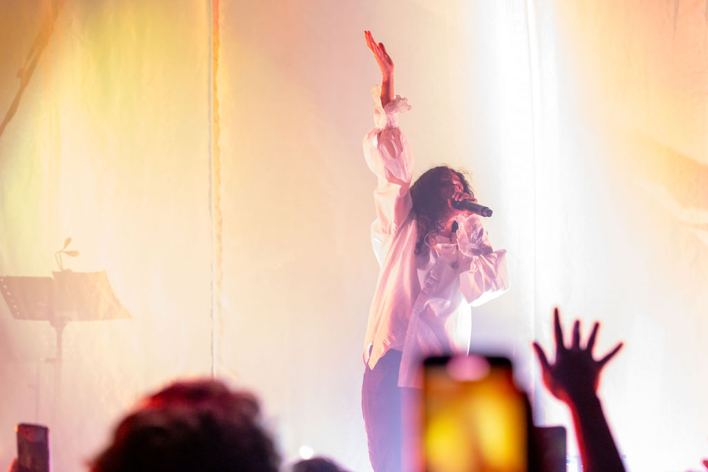 070 Shake performing live on stage at the 9:30 Club in Washington DC under blue concert lighting.