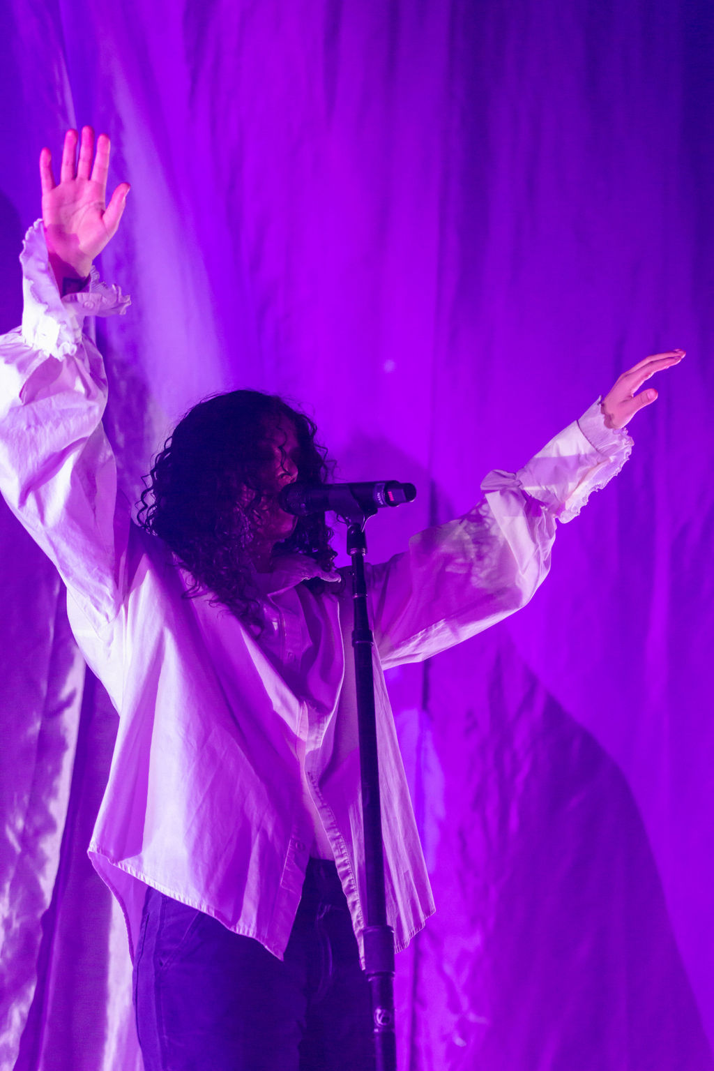 Purple hues between a performing live on stage 