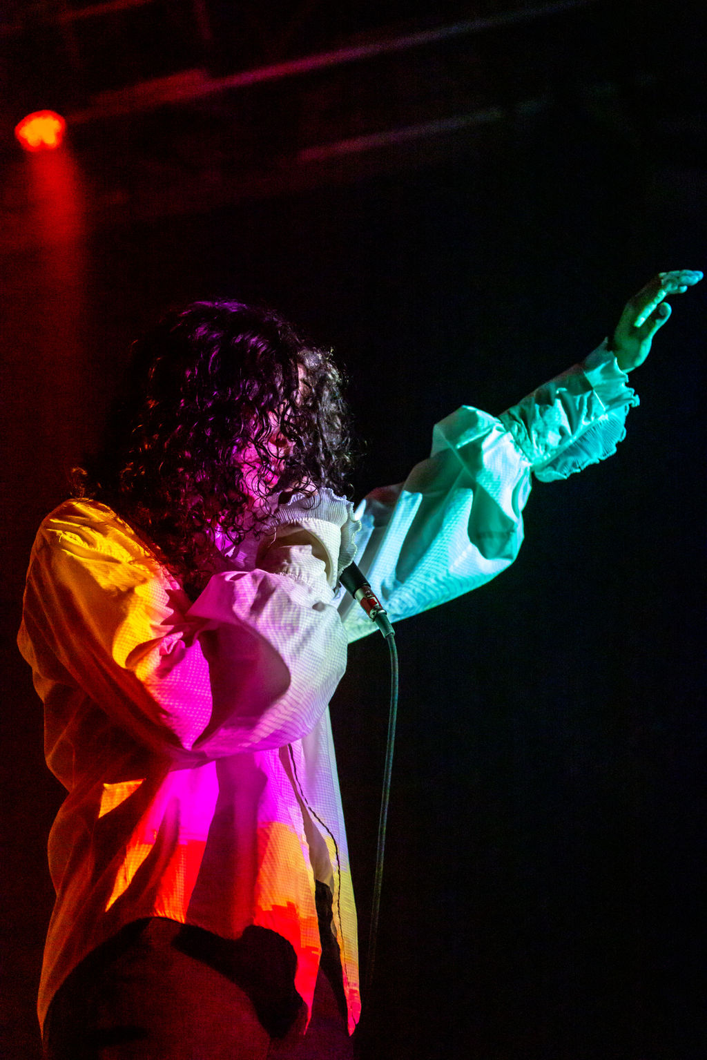 Moody artist spotlight image of 070 Shake at the 9:30 Club in DC, capturing an intimate live performance filled with shadow, tension, and emotional release.