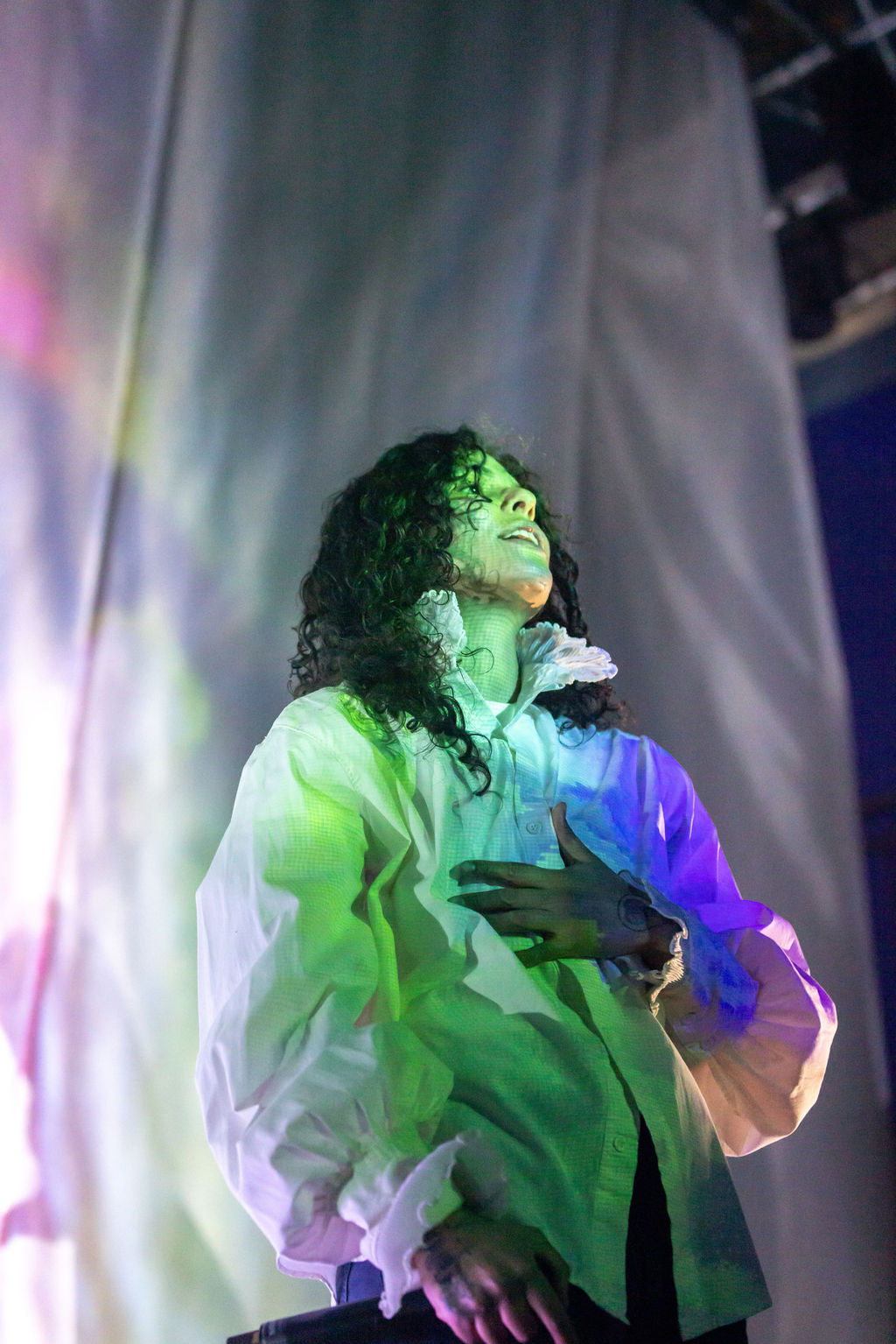 Artist spotlight concert photography of 070 Shake performing at the 9:30 Club in Washington DC, bathed in deep blue light with a haunting and cinematic presence.