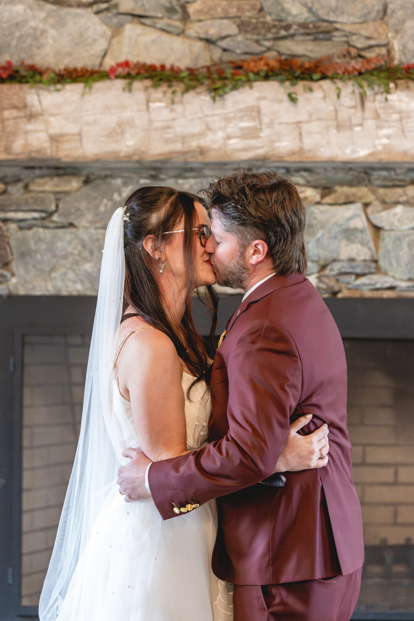 Bride and groom share their first kiss during their Annapolis Maritime Museum & Park wedding ceremony