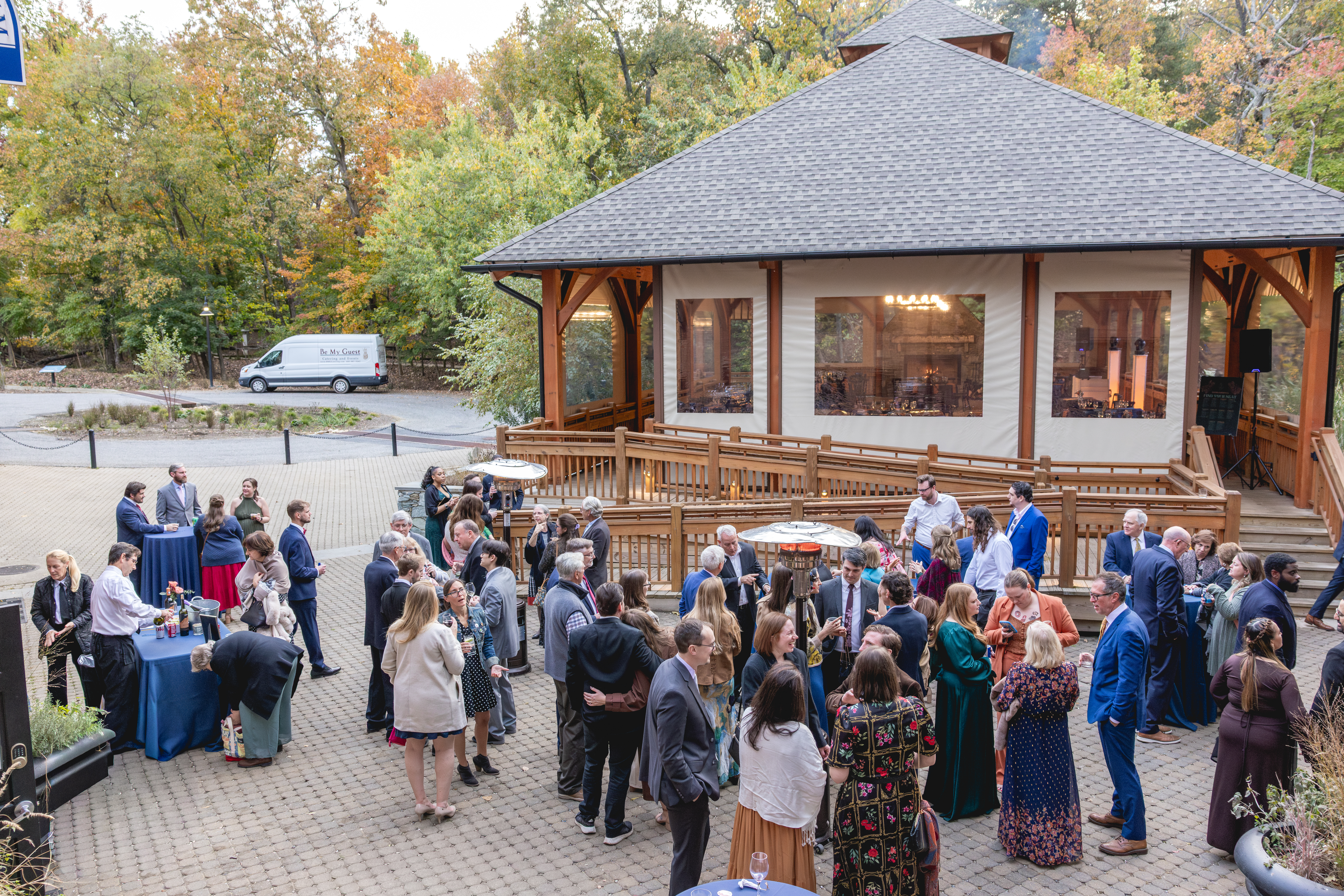 Outdoor cocktail hour with guests mingling outside the pavilion at an Annapolis Maritime Museum & Park wedding in fall