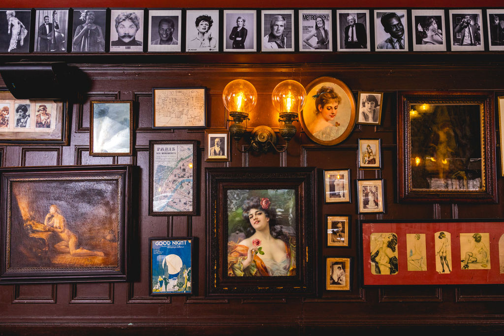 vintage artwork wall inside historic capitol hill restaurant interior