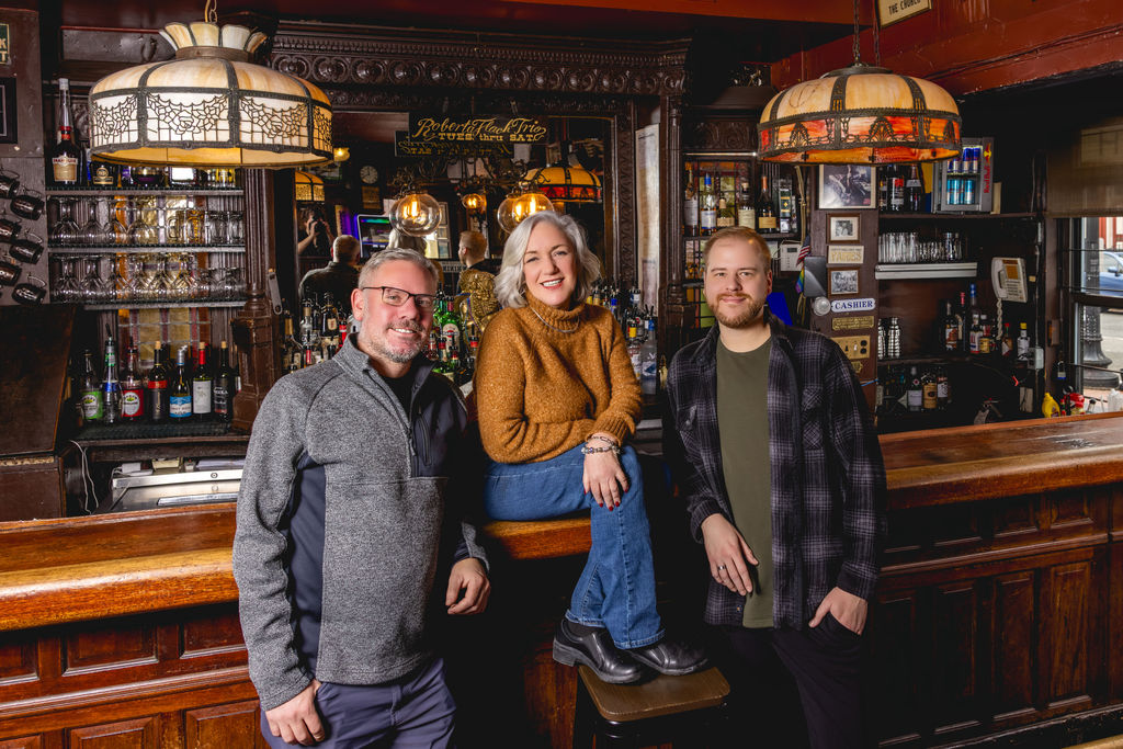 restaurant team portrait behind bar at capitol hill venue branding photography