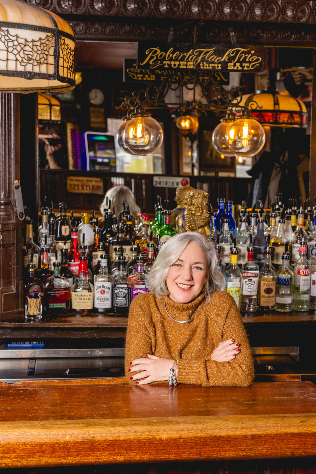 owner portrait seated at bar inside historic capitol hill restaurant