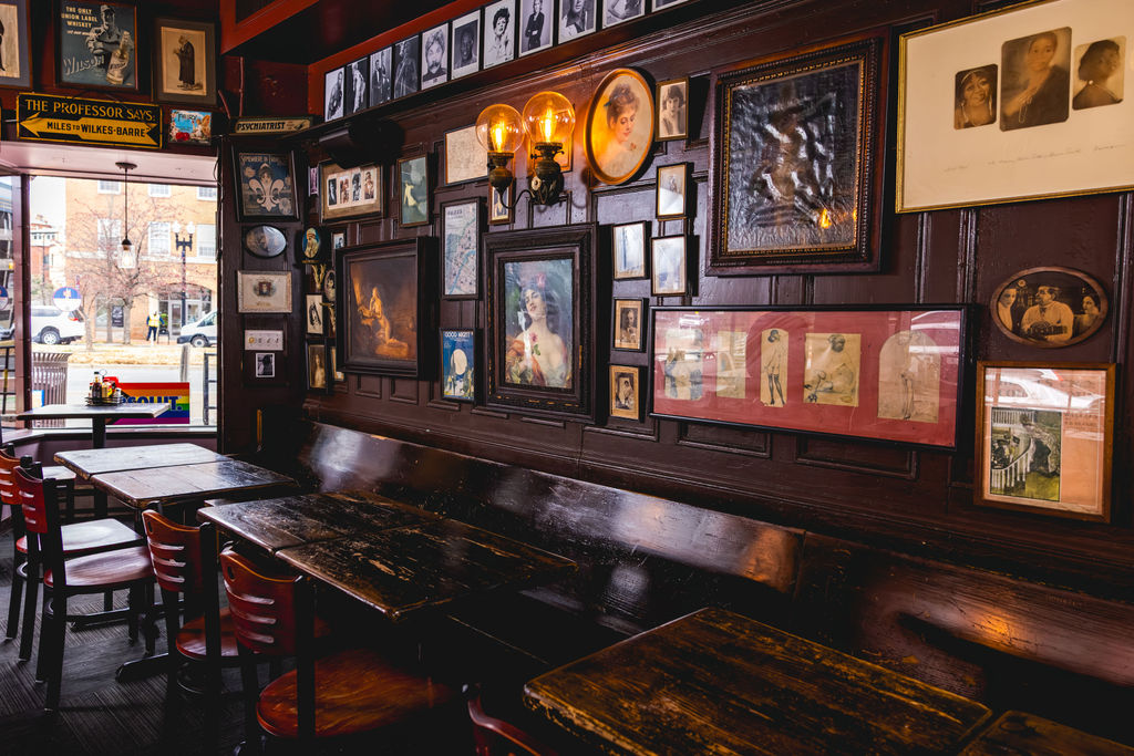 historic restaurant interior with vintage artwork and seating area in capitol hill