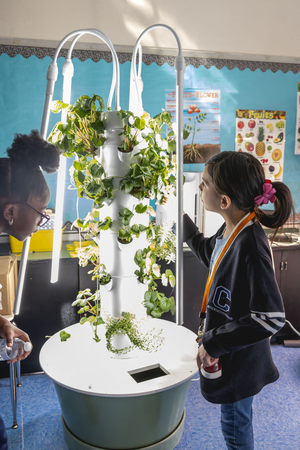 Documentary school photography of students exploring indoor garden and STEM learning at P.S. 272 Curtis Estabrook