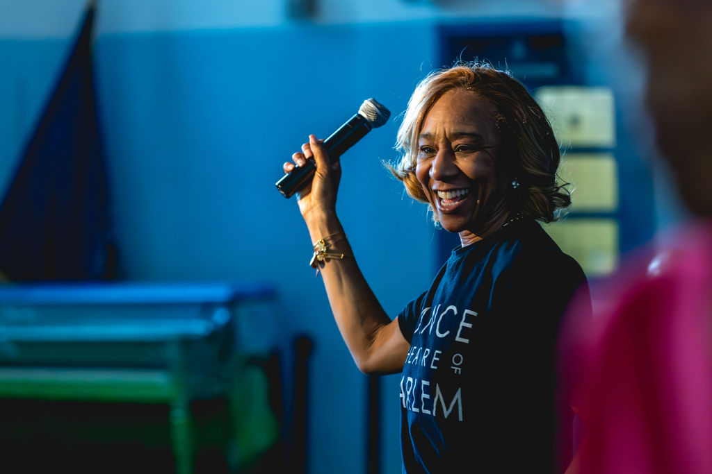 Speaker holding microphone during school event at P.S. 272 Curtis Estabrook in New York City