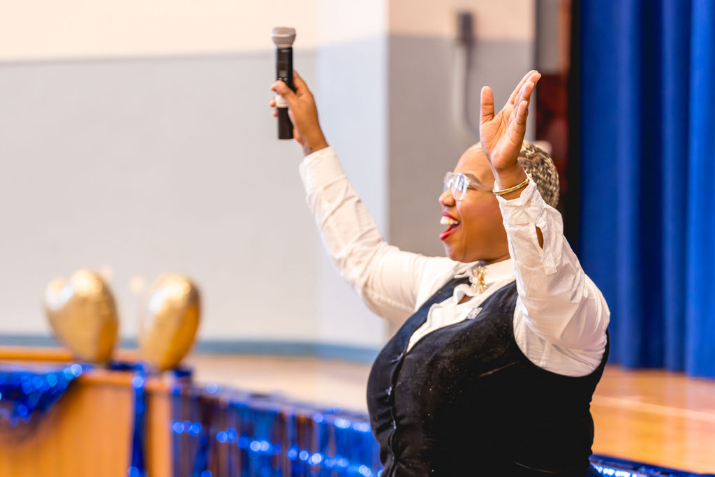 School leader speaking to audience during event at P.S. 272 Curtis Estabrook in Brooklyn NYC