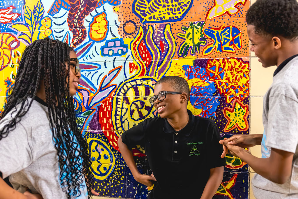 group of students laughing in conversation in a candid school photo