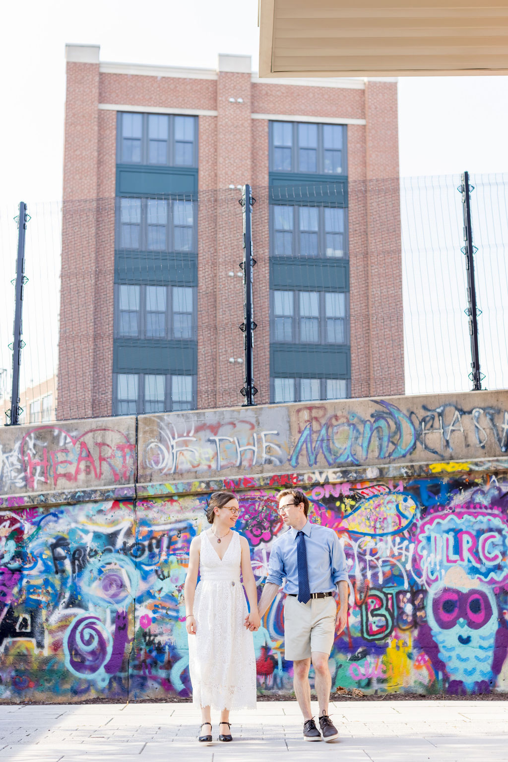 Intimate couple walking through creative neighborhood during Washington DC wedding
